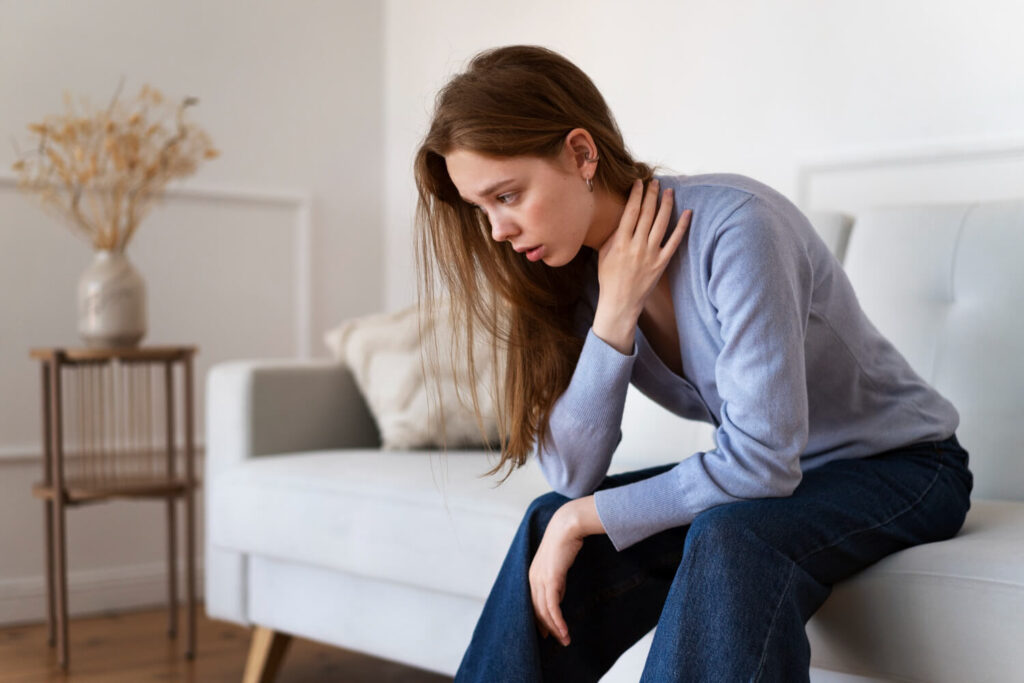 side view anxious woman sitting couch 1